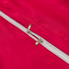 A close-up view of a vibrant pink satin duvet cover featuring a white zipper closure.