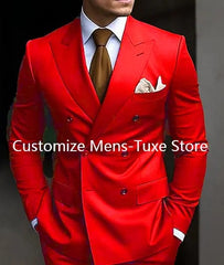 A man wears a vibrant red double-breasted suit with a peaked lapel and a brown necktie.