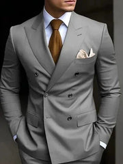 A man wears a grey double-breasted suit with a brown tie and a white pocket square.