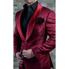 A slim-fit burgundy jacquard blazer with a satin shawl lapel worn over a black shirt.