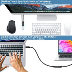 A black USB-C male-to-female extension cable connecting a laptop to another device.