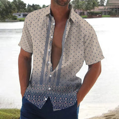 A man wears a short-sleeved button-down shirt with a beige patterned top and a blue floral hem.