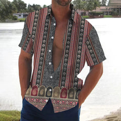 A man wears a short-sleeved button-down shirt featuring a vertical striped and paisley print.