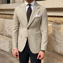 A slim-fitting beige striped blazer with a two-button closure and notched lapels.