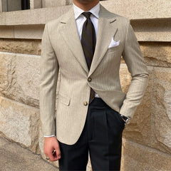 A slim-fitting beige striped blazer with a two-button closure and notched lapels.