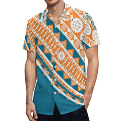 A man wears a short-sleeved button-down shirt featuring a teal and orange Polynesian tribal print.