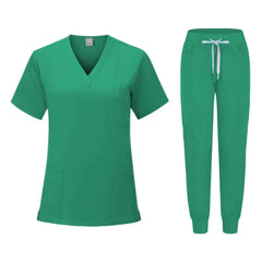 A green women's scrub set featuring a V-neck top with pockets and matching jogger-style pants.