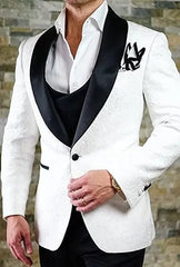 A white patterned tuxedo jacket with a black satin shawl lapel worn over a white dress shirt.