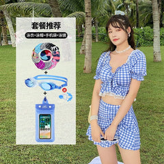 A woman wears a blue and white gingham two-piece swimsuit with a skirt, shown alongside a set of swimming accessories including a cap, goggles, and a waterproof phone pouch.