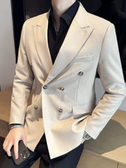 A man wears a slim-fit white double-breasted blazer with a black shirt.