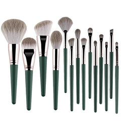 A set of fourteen makeup brushes with soft bristles and dark green handles.