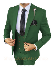 A man wears a slim-fit, three-piece forest green suit with a polka-dot tie and a lapel pin.