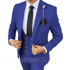 A man wears a royal blue three-piece suit with a white shirt and a black polka dot tie.