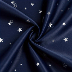 Navy blue blackout curtains featuring a pattern of silver stars.