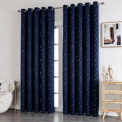 Two navy blue blackout curtains with a white star pattern hang on a silver grommet rod.
