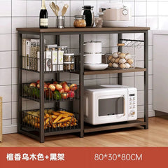 A three-tier kitchen storage rack with a dark wood finish and black metal frame featuring wire baskets and a microwave shelf.