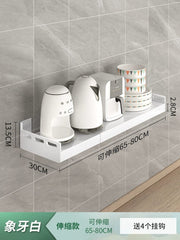 A white, wall-mounted, extendable kitchen storage rack holding small appliances and bowls.