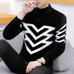 A man wears a black mock neck sweater featuring a large white chevron pattern on the chest and arms.