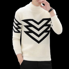 A man wears a cream-colored mock neck sweater featuring a black chevron pattern on the chest and arm.