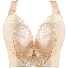 A beige lace push-up bra with adjustable straps and a decorative charm at the center.