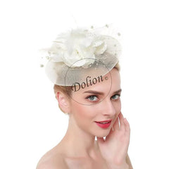 A woman wears a cream-colored mesh fascinator hat adorned with a large flower and small pearls.