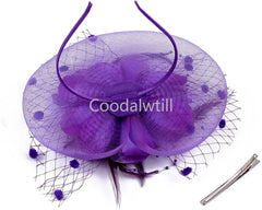 A purple fascinator hat featuring a floral design, mesh veil with pom-poms, and a metal hair clip.