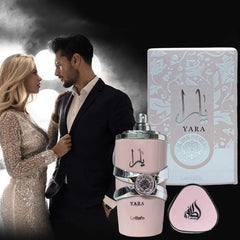 A bottle of Lattafa Yara eau de parfum with its box, featuring a couple in the background.