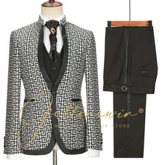 A three-piece men's suit featuring a black and white geometric patterned jacket and black trousers.