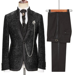 A black glittery three-piece suit with a shawl lapel, cravat, and matching trousers.