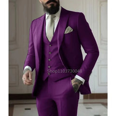 A man wears a slim-fit, three-piece purple suit with a white shirt and a light-colored tie.