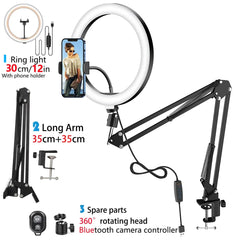 A 12-inch LED ring light on an adjustable folding arm stand with a phone holder and accessories.