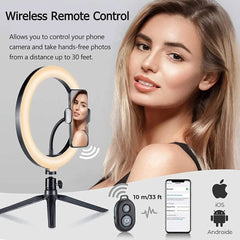 A ring light on a tripod stand with a phone holder and a wireless remote control.