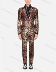 A man wears a two-piece leopard print velvet suit with a maroon lapel and a polka dot shirt.