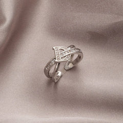 A silver-toned open ring featuring a letter D design accented with small zircon stones.