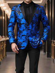 A man wears a blue and black paisley patterned blazer with a black lapel and one button closure.