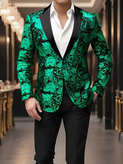 A man wears a green and black paisley patterned blazer with a black lapel and a white shirt.