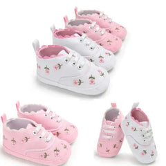 Baby girl canvas crib sneakers featuring a cute floral print and soft soles.