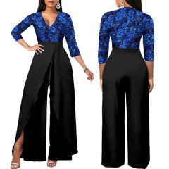 A woman models a blue floral-print top jumpsuit with wide-leg black trousers and a front slit.