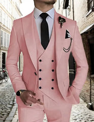 A man wears a light pink three-piece suit featuring a double-breasted vest and peak lapels.