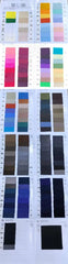 A comprehensive fabric swatch book displaying a wide variety of colors and textures for men's suits.