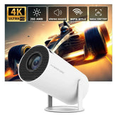 A white Magcubic portable projector on a stand against a background showing a race car.