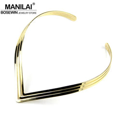 A gold-toned, three-layered V-shaped metal torque choker necklace for women.