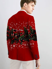 A man wears a red blazer featuring a festive Christmas print of pine branches and snowflakes.