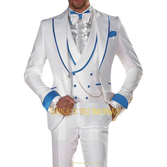 A man wears a white three-piece suit with blue trim, a ruffled shirt, and a blue bow tie.
