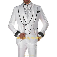 A man wears a white three-piece suit with black trim on the jacket, vest, and cuffs.