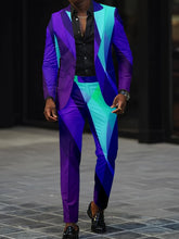 A man wears a slim-fit suit featuring a vibrant, geometric digital print in shades of blue and purple.