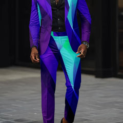A man wears a slim-fit suit featuring a vibrant, geometric digital print in shades of blue.