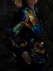 A person wears a slim-fit blazer featuring a vibrant, multicolored stained-glass digital print.