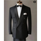 A black double-breasted tuxedo jacket featuring a satin shawl lapel and a white pocket square.