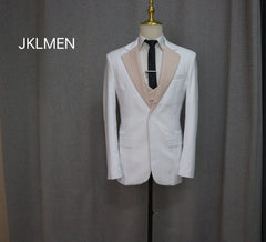 A white slim-fit suit jacket with a beige lapel and matching vest worn over a black tie.